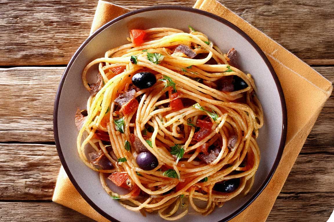 A plate of Spaghetti Puttanesca with olives, capers, and a rustic setting