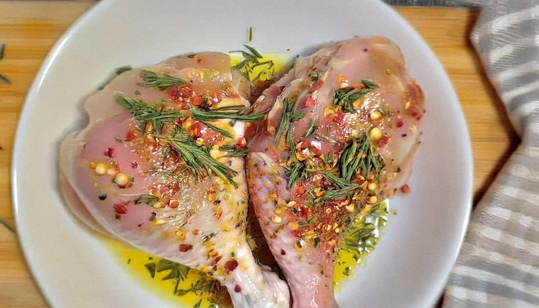 hand-drying-chicken-breast-with-paper-towel-on-wooden-board